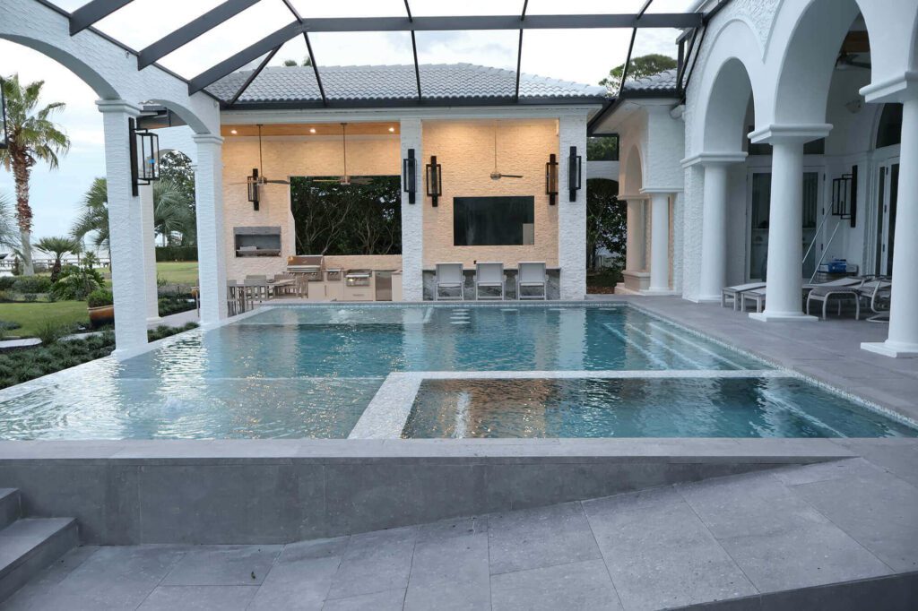 Gunite pool and raised spa in front of a covered outdoor living room